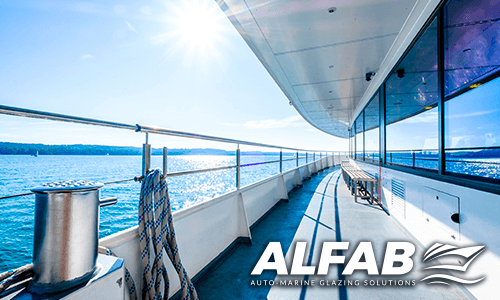 Deck of a boat, ocean reflected in the boat window